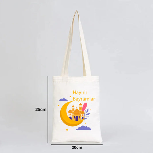 20x25 cm ölçülü ham bez kitap çantası, uzun kulplu; hilal ve cami illüstrasyonlu “Hayırlı Bayramlar” Ramazan Bayramı çantası.