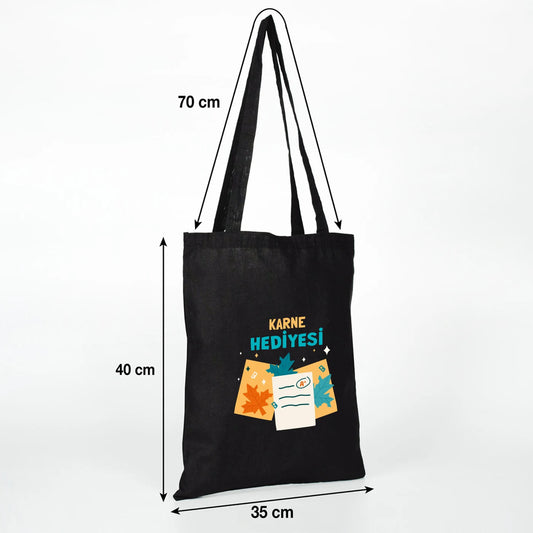 siyah baskılı ham bez çanta üzerinde karne hediyesi temalı baskı detayı