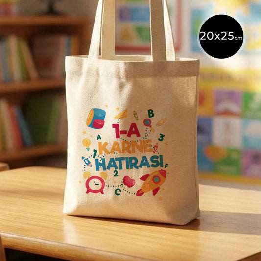 20×25 cm doğal renkli pamuk tote çanta, ön yüzünde karne günü temalı renkli baskı bulunan okul çantası.