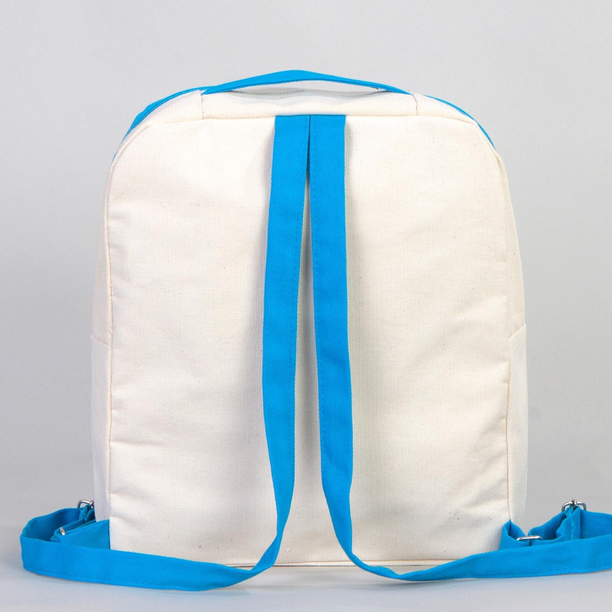 İyi Tatiller baskılı, turkuaz fermuarlı ve turkuaz askılı 25×32×10 cm bez sırt çantası; kitap ve balon desenli okul temalı çanta